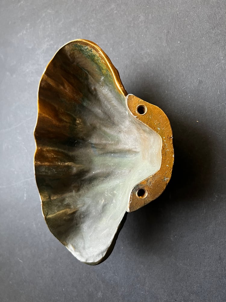 Image of Curved Bronze Door Handle in the Shape of a Seashell