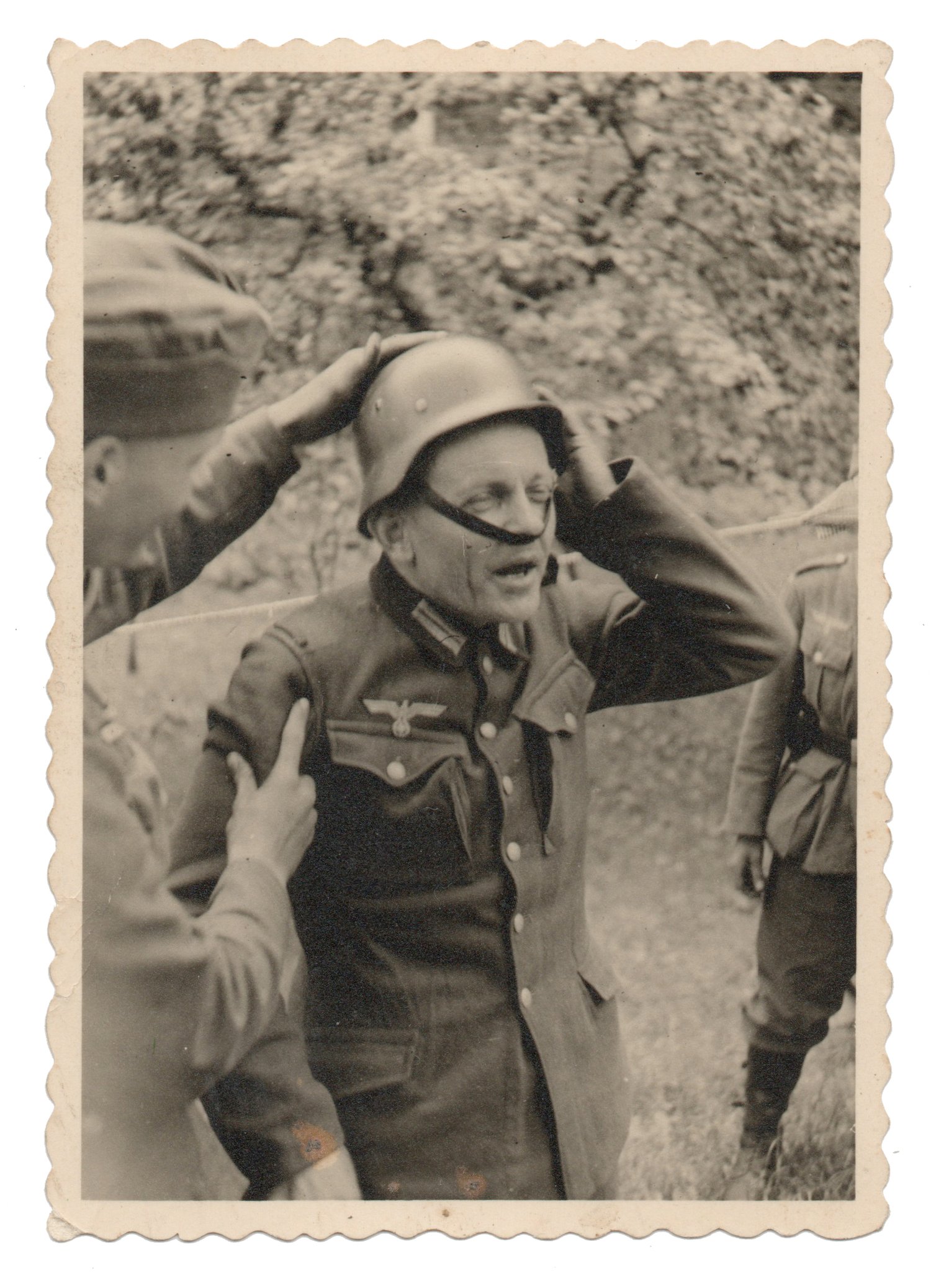 Image of Unknown: struggling with his helmet, Germany ca. 1940s