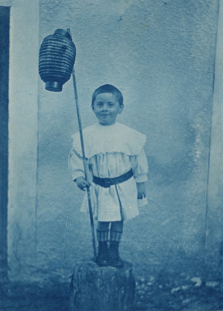 Image of Unknown: smiling boy with a lantern, France ca. 1900