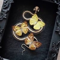 Image 2 of Viper skeleton and yellow butterflies