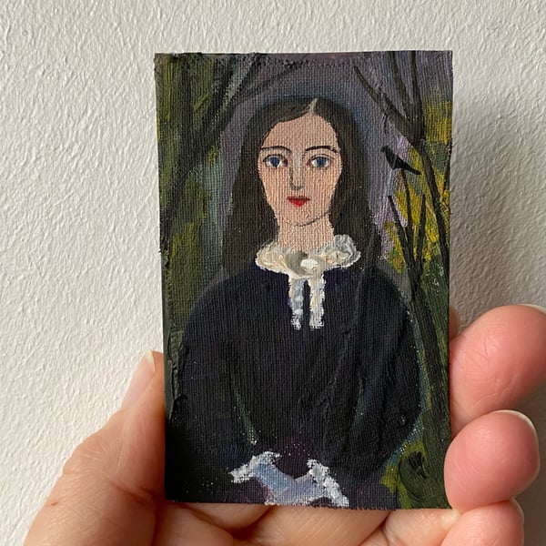 Image of Woman in wintry landscape (dark afternoon) - tiny portrait 