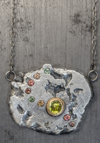 Image 1 of 'crater' - Recycled silver and 9ct pendant with peridot and sapphires