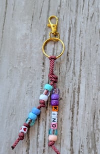 Image 1 of Colorful beaded keychain with the word KIND 