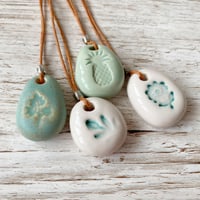 Image 1 of Handmade Ceramic Pebble Pendant – Wearable Essential Oil Diffuser