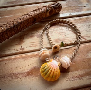 Image of Hawaiian sunrise or moonrise shell necklace with golden pukas and a locking seaglass clasp