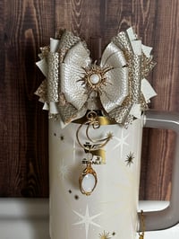 Image 1 of Starlight Shimmer Cream and Gold Sun, Moon, and Star Tumbler Straw Topper Bow