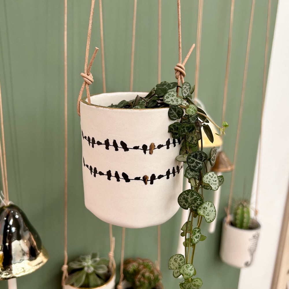 Porcelain hanging birds on a wire planter