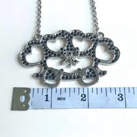 Image 2 of black brass knuckle bow heart necklace 