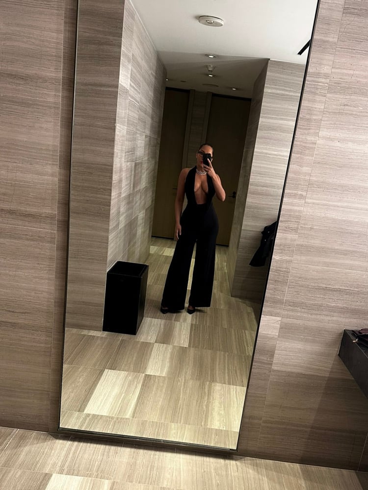 Image of BLACK LOW CUT HALTER FLARED JUMPSUIT (M)