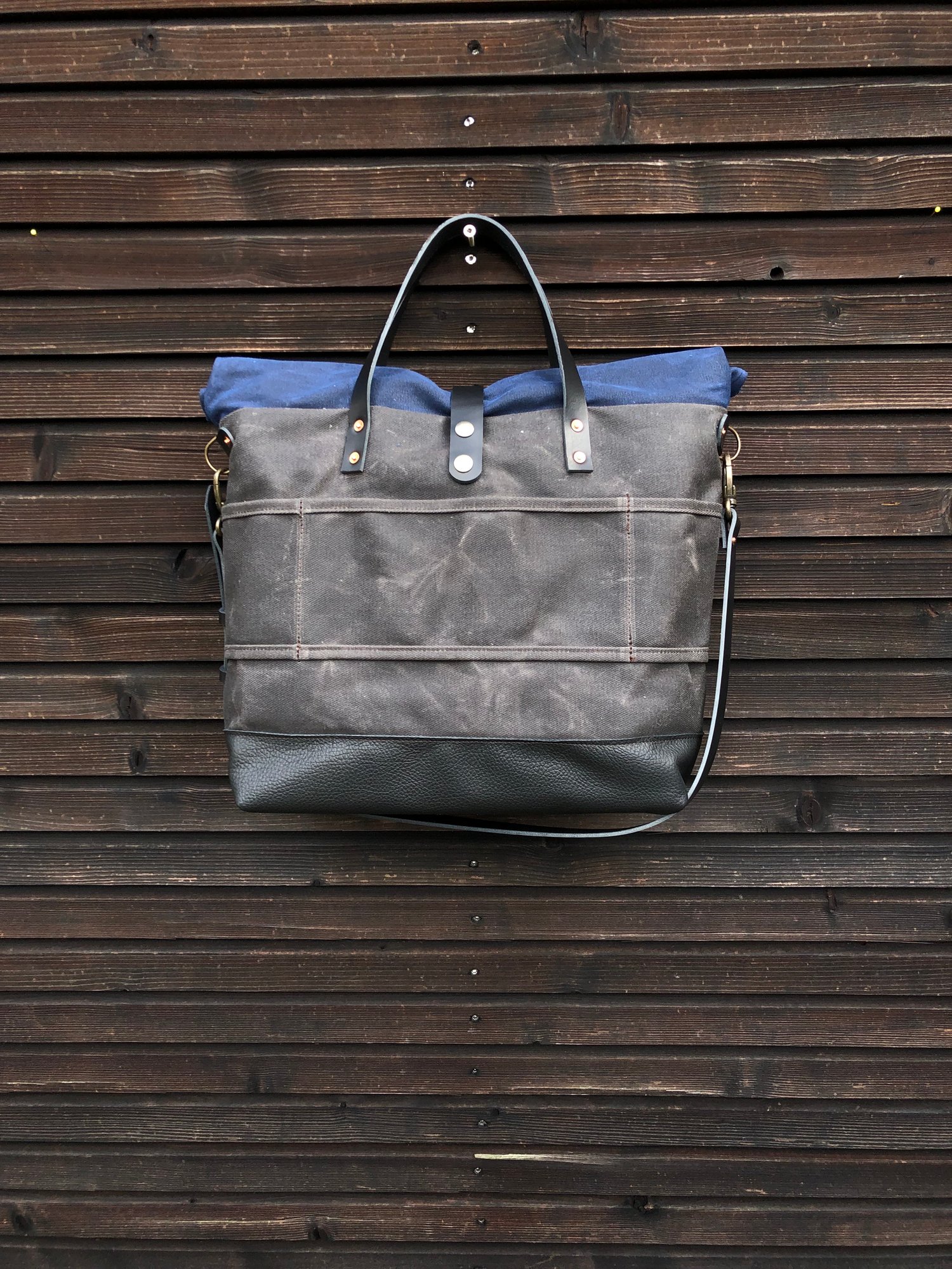 Image of Waxed canvas roll to close top tote bag with luggage handle attachment leather handles and shoul