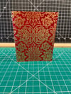 Softcover journal with red and gold cover