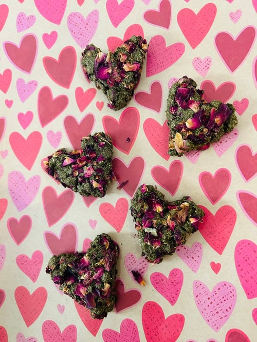 Image of Heart shaped healthy munchy treat bite with rose petals
