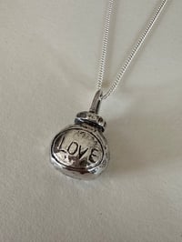 Image 1 of love/hate Marmite pendant