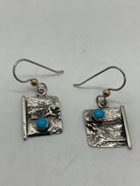 Reticulated sterling silver earrings with turquoise accent stone.