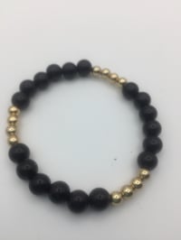 Image 2 of Black & Gold bracelets