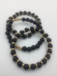 Image 1 of Black & Gold bracelets