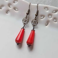 Image 1 of Art deco bronze floral cut out earrings handmade with faceted opaque red coral Czech glass drops
