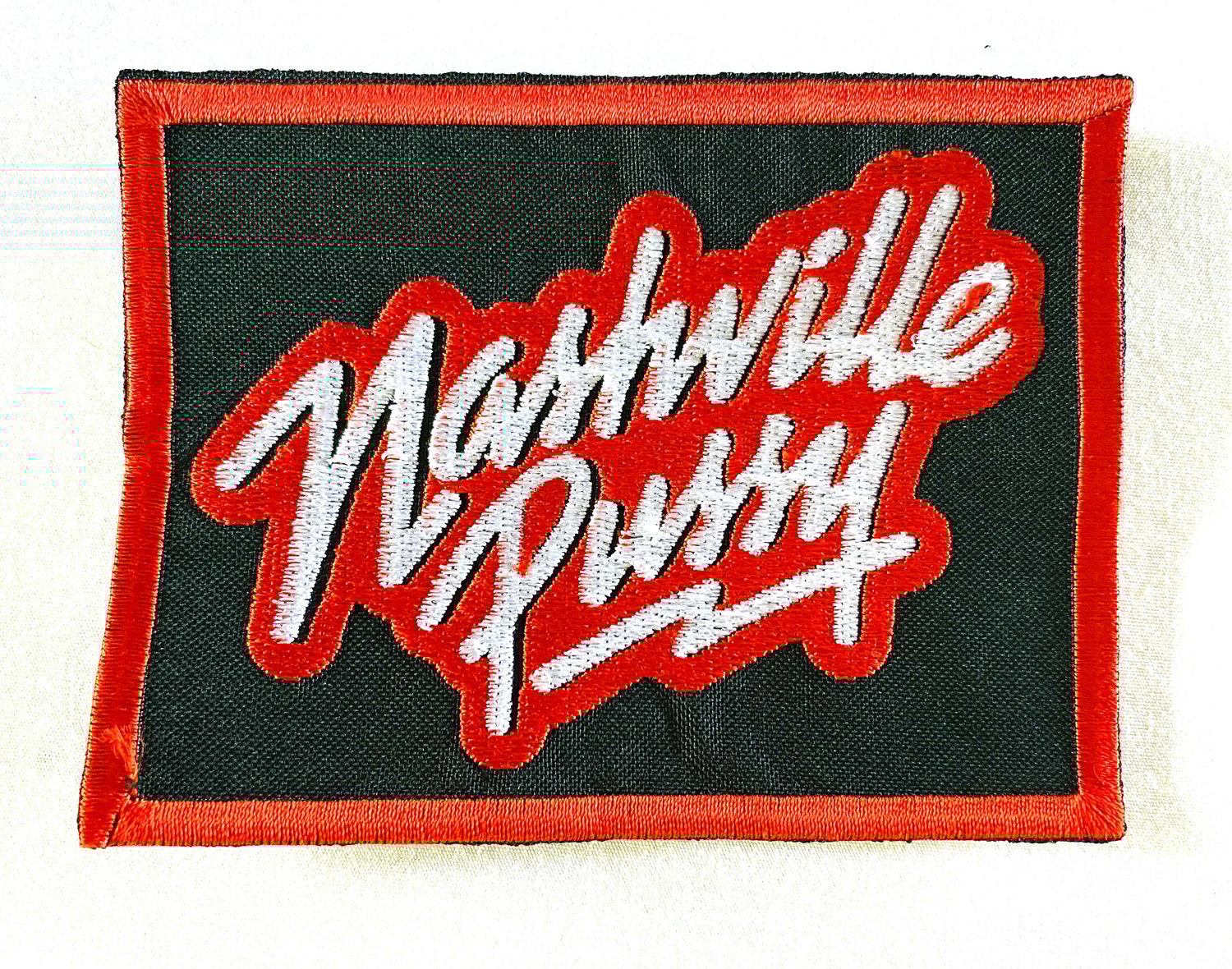 Image of NASHVILLE PUSSY - LOGO - 8 X 10.5CM - AUSSIE TOUR PATCH. BLACK, RED & WHITE. EMBROIDERED. PATCH