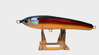 Image 1 of 50g Black Top, Reddish Body with a Goldish Tint  Floating Stick Bait