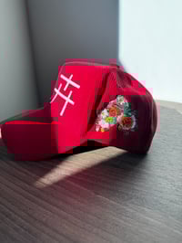 Image 2 of “Flowers”  in Chinese, red corduroy hat. 