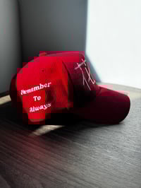 Image 3 of “Flowers”  in Chinese, red corduroy hat. 