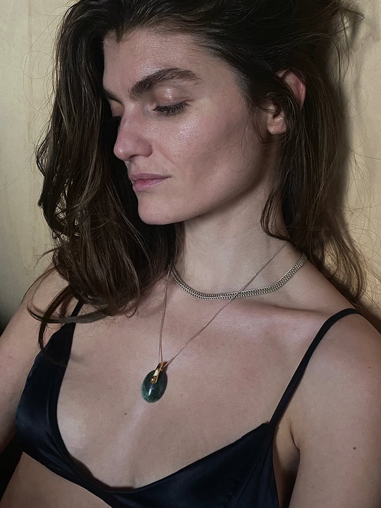 TIMELESS, ESSENTIAL, AND EVERYTHING IN BETWEEN

This pendant comprises a gemstone cabochon which is gold bond-ed by a harp clasp.  
The closure is 18kt gold plated brass.
Each stone element variance in size and color, the small size is approx 3cm and the big size Obi stone pendant is approx 4cm. 
The one of a kind gemstones contain the loveliest shades of moss green, tawny, umber and warm tan of brown. From transparent parts with patterns to creamy evenly colored appearance.
M...