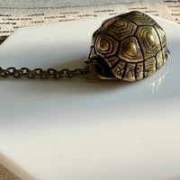 Image 1 of Bronze Ringing Turtle Shell | Necklace