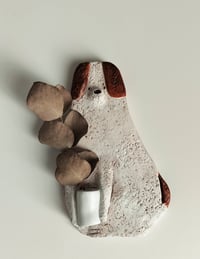 Sitting dog and vase
