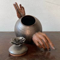 Image 2 of a golden handheld teapot