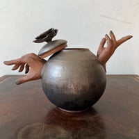 Image 3 of a golden handheld teapot