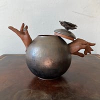 Image 4 of a golden handheld teapot