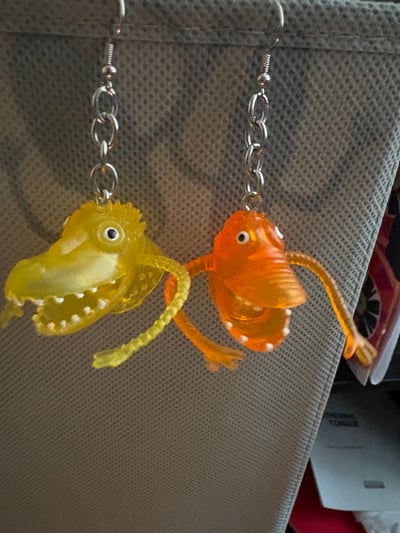 Image of monster finger puppet mismatched earrings