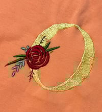 Image 1 of Coral Baby Romper with Rose Flower and Yellow “O”