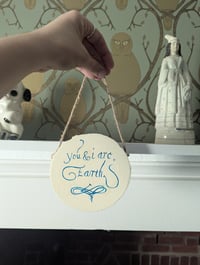 Image 3 of You and I are earth text on woodslice