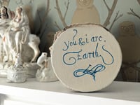 Image 1 of You and I are earth text on woodslice