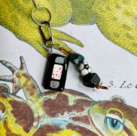 Image 3 of out there keychain