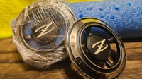 Image 1 of Pillar vent emblem - New OEM - set of Left/Right