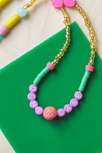 Image 4 of Don't Care alphabet beaded necklace