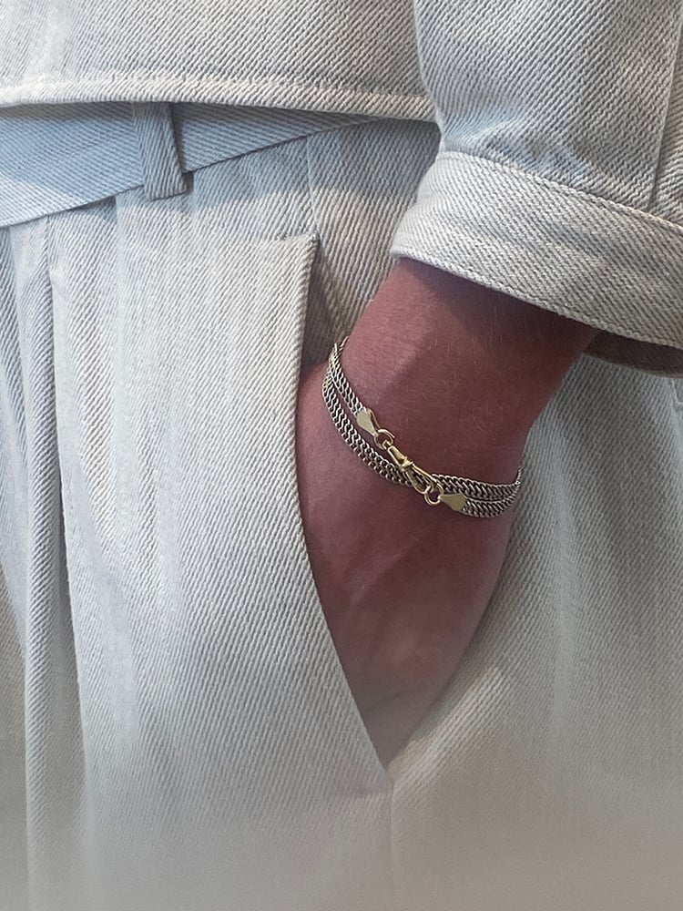 REFLECTING IN THE MORNING, SHINING BY NIGHT

Our Silver Wrap-Around Bracelet wraps elegantly two times around the wrist.
The fluid open structure chain is luminous yet lightweight and made for living in.

Whether you prefer the cool shine of silver, the warm glow of gold it can all be found in this piece. 
The 22mm musqueton clasp (and connections parts) which functions as a ornament is available as a solid sterling 925 silver or solid 18K gold part.

Wondrous in sentiment, ...