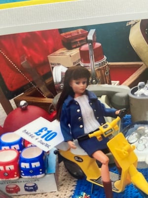Image of Barbie doll on a Sindy scooter