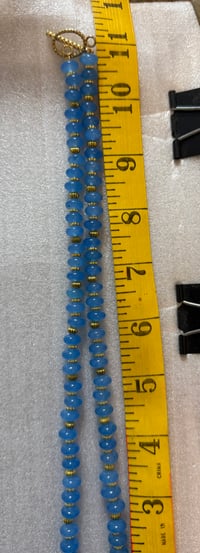 Image 2 of Chalcedony with gold tone spacers and gold tone sun/moon pendant.
