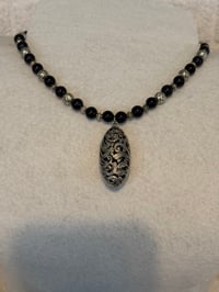 Image 1 of Onyx with silver tone spacers and silver tone pendant.