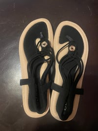 Image 1 of Forever 21 flat black sandal with strap on the back.