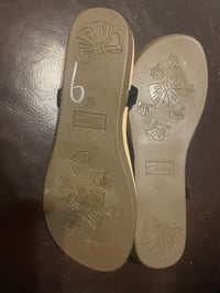 Image 2 of Forever 21 flat black sandal with strap on the back.