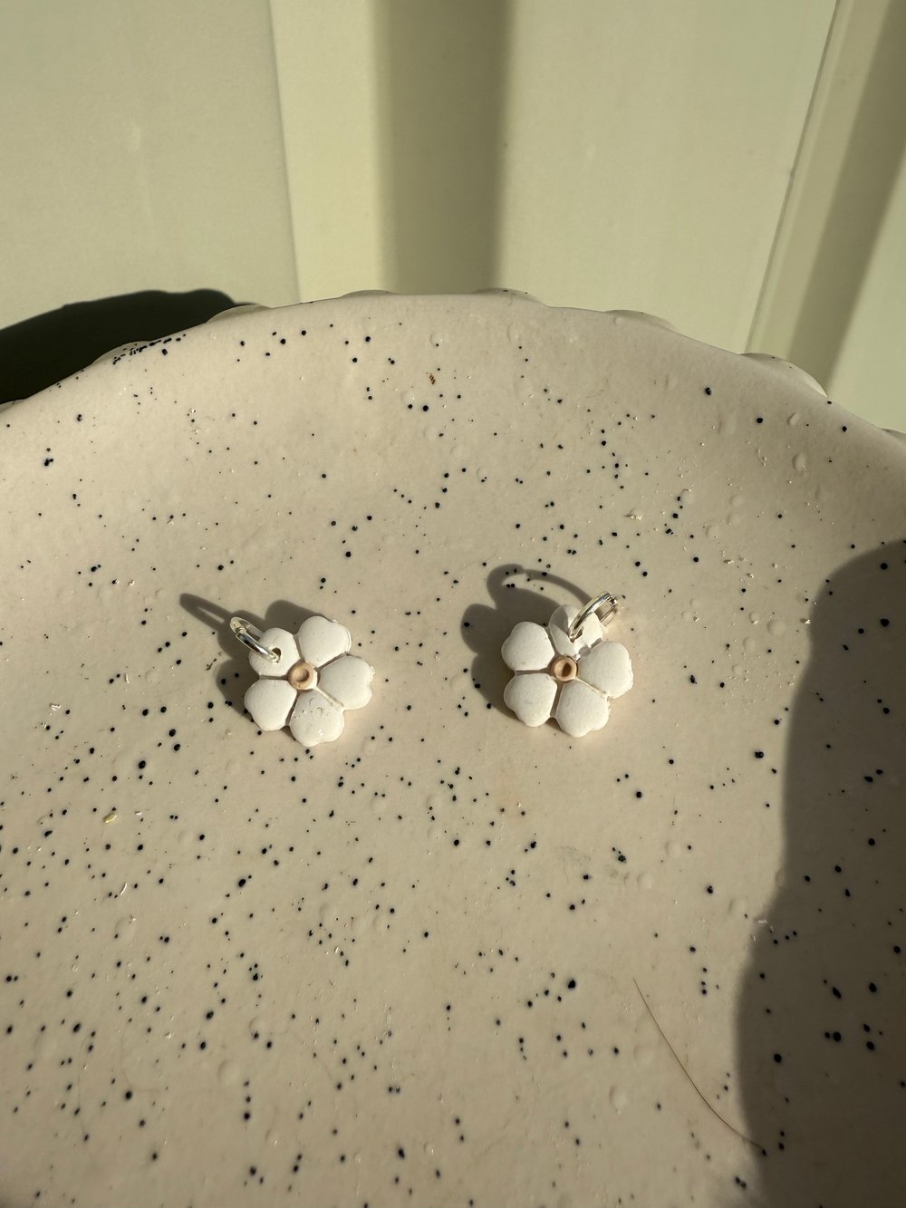 Image of white and beige daisy sleeper charms