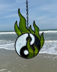 Image 3 of yin yang in green flames