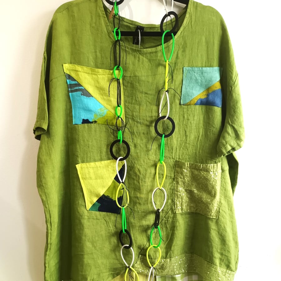 Image of green linen tunic with sparkling accents