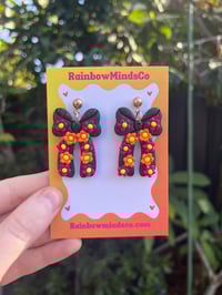 Cosmic bloom bow earrings 