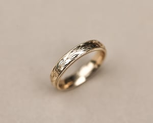 Image of 9ct yellow gold 4mm ‘Olive leaf’ and milled edge engraved ring