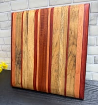 Image 1 of Black Limba, Padauk, and Cherry Cutting Board